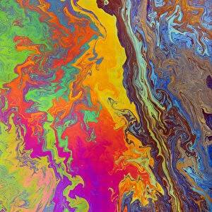Abstract pattern in oil spilled in small stream, Costa Rica