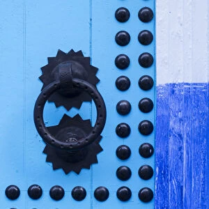 Africa, Morocco, Chefchaouen. Detail of blue door and doorknocker