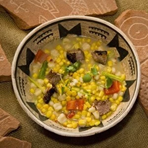 Bowl of Zuni corn soup made with ingredients of corn, posole, goat meat, chili pepper