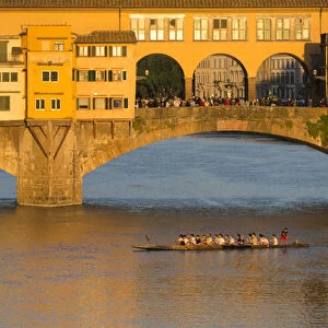 Europe, Italy, Florence. Golden light of late afternoon illuminates the Ponte Vecchio