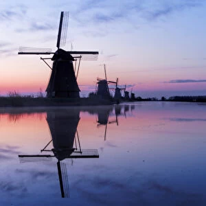 Europe; Netherlands; Kinderdijk; Windmills at Sunrise along the canals of Kinderdijk
