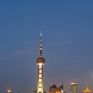 Pearl Tower over Pudong district skyline and Huangpu River Shanghai, China