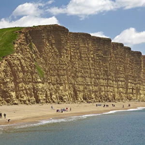 People on beach by West Bay Cliffs, Jurassic Coast World Heritage Site, West Bay
