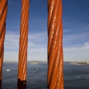 San Francisco and Alcatraz Island as seen through the cables of the Golden Gate Bridge
