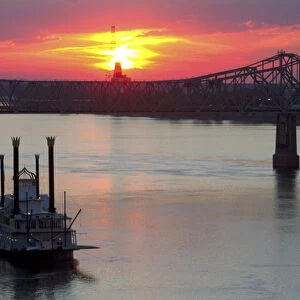 Sunset with steamboat under the Natchez-Vidalia Bridges spanning the Mississippi