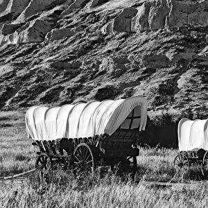 USA, Nebraska, Scotts Bluff National Monument. Covered wagons in field. Credit as