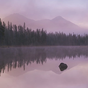USA, Oregon, Willamette National Forest. Foggy sunrise on Scott Lake and Three Sisters mountains