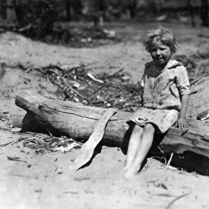 ABANDONED CHILD, 1917. An abandoned child sitting on drift wood, Oklahoma City, Oklahoma
