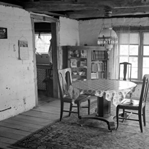 ADOBE HOUSE, 1940. A woman in an adobe house in Pie Town, New Mexico. Photograph by Russell Lee