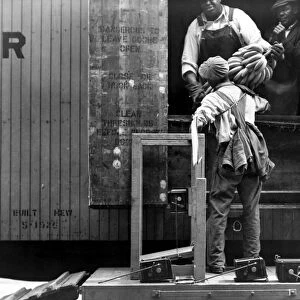 ALABAMA: BANANAS, c1937. Workers loading bananas onto a railroad freight car in Mobile, Alabama. Photographed by Arthur Rothstein, c1937