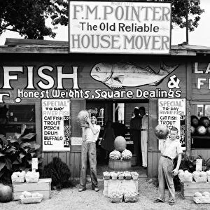 ALABAMA: FOOD STAND, 1936. A roadside fruit and fish stand near Birmingham, Alabama. Photographed by Walker Evans, 1936