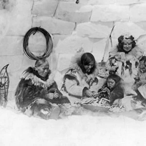 ALASKA: ESKIMO DINNER. An Eskimo family and the photographers wife eating a dinner
