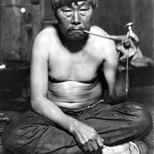 ALASKA: ESKIMO MAN. An Eskimo man smoking a pipe, Nome, Alaska
