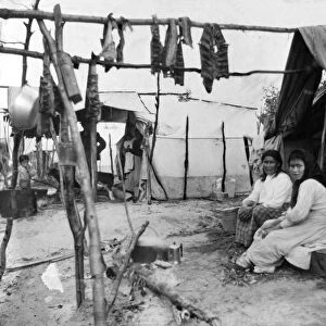 ALASKA: ESKIMOS, c1916. Two Eskimo women sitting outside their tent, with fish