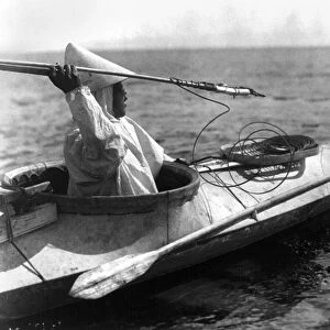ALASKA: HARPOON, c1929. An Eskimo man seated in a kayak prepares to throw a harpoon