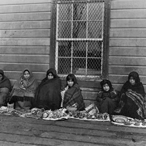 ALASKA: TLINGIT WOMEN, 1905. Tlingit women and girls displaying handcrafted items