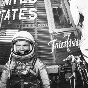 American astronaut and politician. Pictured with the Friendship 7 space capsule shortly before Glenn became the first American to orbit the Earth, Feb. 20, 1962