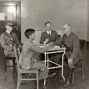 ANGEL ISLAND, 1923. A Chinese immigrant being interviewed upon his arrival at the