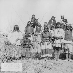 APACHE CAMP, 1886. A group of Apache Native American men, women, and children photographed