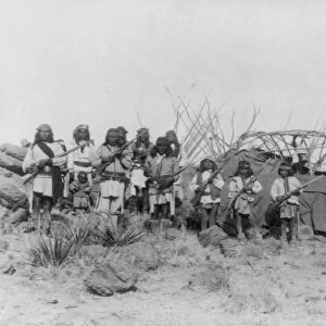 APACHE WARRIORS, 1886. A group of Apache Native American men and boys posing with