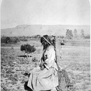 APACHE WOMAN, 1873. An Apache woman with a baby in a cradleboard