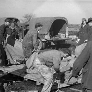 ARKANSAS: FLOOD CAMP, 1937. Setting up a tent in a camp for white flood refugees at Forrest City