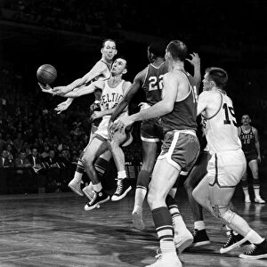 BASKETBALL GAME, c1960. Bob Cousy of the Boston Celtics (number 14) jumps for the ball during a game against the Los Angeles Lakers, c1960