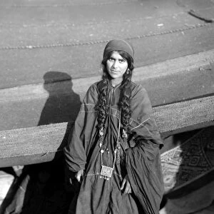 BEDOUIN WOMAN, c1910. Portrait of a Bedouin woman outside her tent in the Middle East