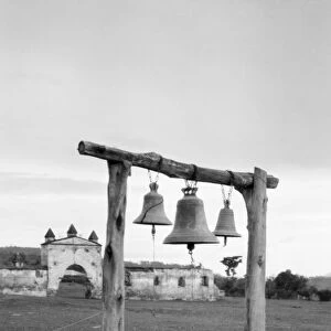 BELLS, c1920. Bells in the yard of a church in Guatemala or Cuba. Photograph by Arnold Genthe