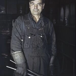 BLACKSMITH, 1943. Daniel Anastazia, a blacksmiths assistant, at the roundhouse