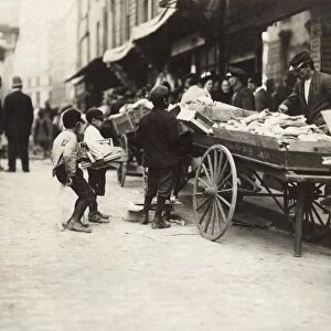 BOSTON: THIEVES, 1909. Two boys stealing from a pushcart vendor, Boston, Massachusetts