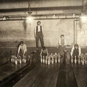 BOWLING ALLEY, 1910. Pin boys working with a supervisor in the Subway Bowling Alleys in Brooklyn