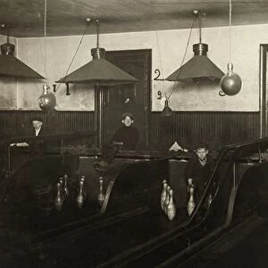 BOWLING ALLEY, c1908. Pin boys working at a bowling alley until late at night in Pittsburgh