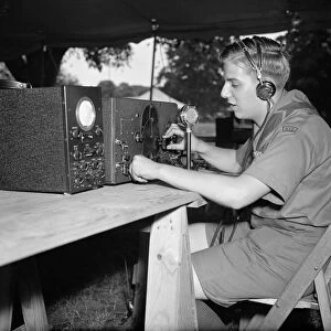 BOY SCOUTS: RADIO, 1937. Larry Le Kashman operating a short-wave radio that will