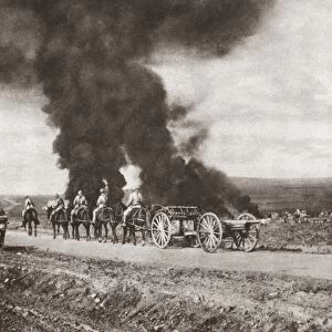 British artillery passing on a road and targeted by enemy air raid bombers, who instead struck houses in a nearby village, on the Balkan front during World War I. Photograph, c1916