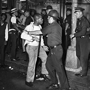 BROOKLYN: RIOTS, 1964. A confrontation between protesters and police at the corner Fulton Street