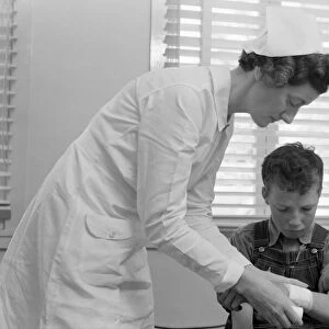 CALIFORNIA: HEALTH CLINIC. A boy receiving medical attention at a health clinic