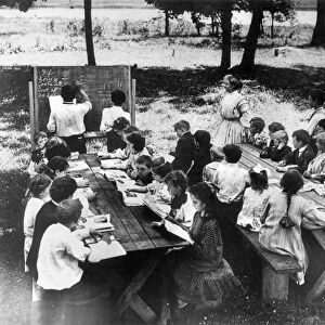 CAMP ALGONQUIN: MATH CLASS. An open-air school at Camp Algonquin with two boys