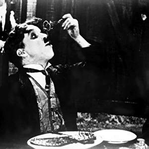CHAPLIN: GOLD RUSH. 1925. Charlie Chaplin eating his shoe in a scene from his film The Gold Rush, 1925