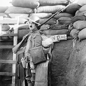 CHAPLIN: SHOULDER ARMS. Charlie Chaplin, English actor and comedian, in a scene from Shoulder Arms, 1918