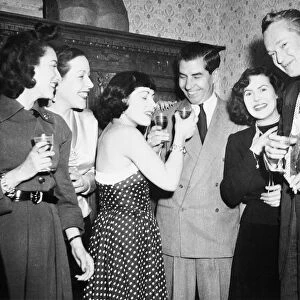 CHARLES LUCKY LUCIANO (1897-1962). American gangster. Luciano (center) at a party in Rome, 1949