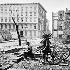 CHARLESTON RUINS, 1865. Two men amongst the ruins of Charleston, South Carolina with the Mills House in the background. Photograph by George Barnard, April 1865