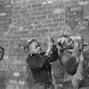 CHICAGO: CHILDREN, 1941. Boys playing and pretending that they are shooting machine