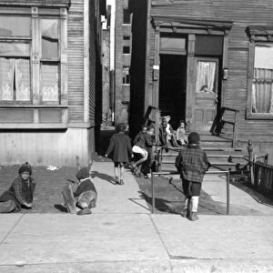CHICAGO: CHILDREN, 1941. Children playing outside of an apartment building on the