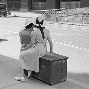 CHICAGO: COMMUTERS, 1940. Two women waiting for a street car in Chicago, Illinois