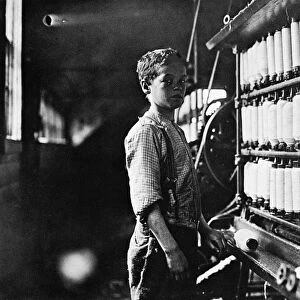 CHILD LABOR, 1909. Twelve year old John Dempsey working in the mule-spinning room