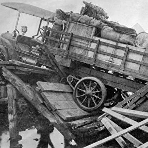 CHINA: BROKEN BRIDGE, 1913. An American truck stuck on a broken bridge in China