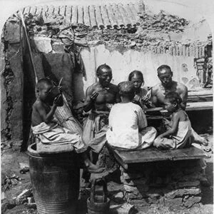 CHINA: FAMILY, c1900. A Chinese family eating a meal at their home in Tientsin