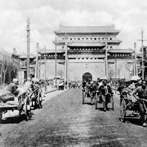 CHINA: PEKING, c1900. Rickshaws, carts, and people on Chien-men Street with the