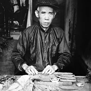 CIGAR MAKER, 1920. Portrait of Lee Ying, a Chinese cigar maker in his shop in Washington D